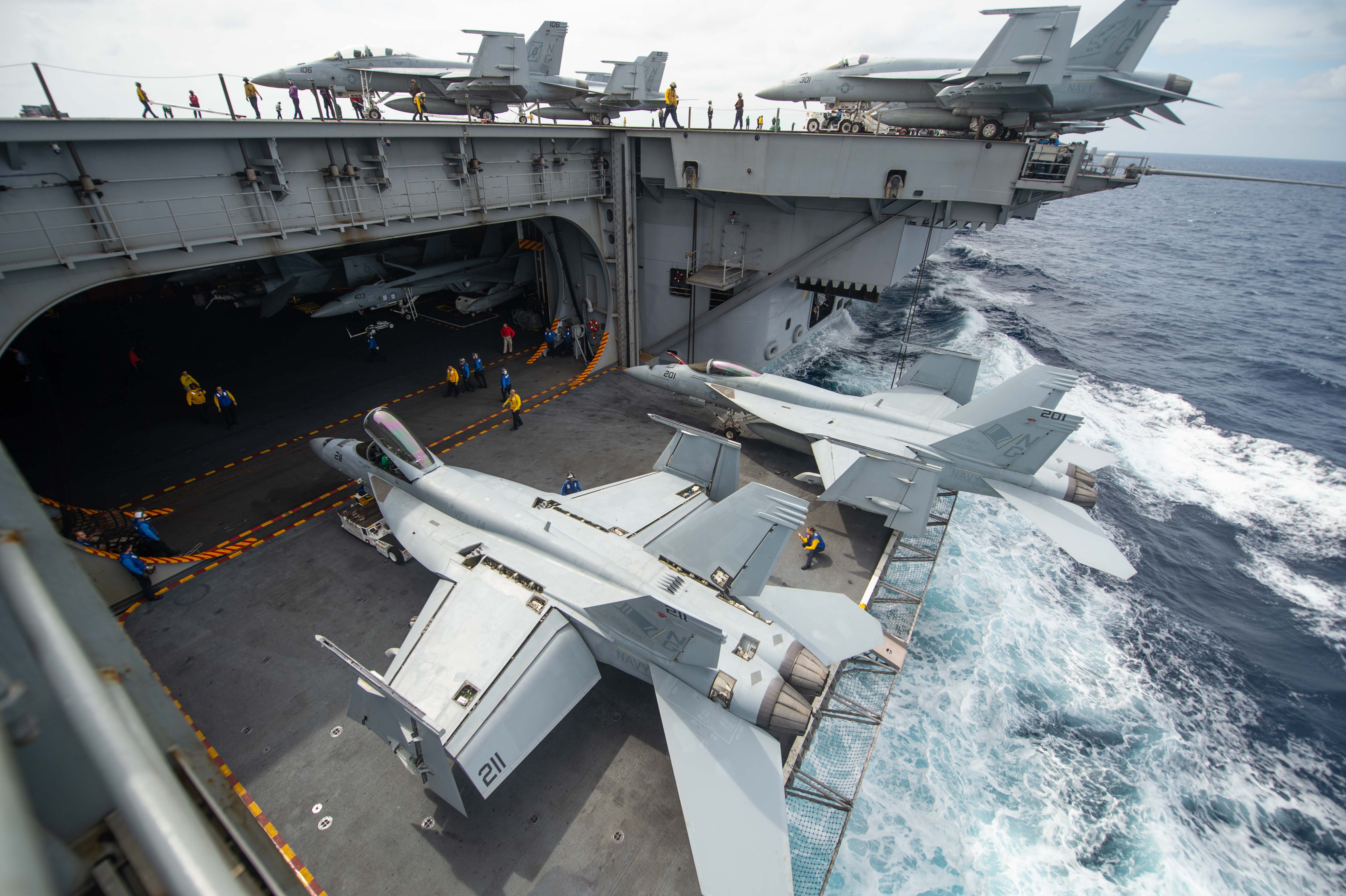 Пара F/A-18E Super Hornet 14-й истребительно-бомбардировочной эскадрильи на подъемнике атомного авианосца  USS John C. Stennis (CVN 74), типа Nimitz, фото сделано 3 декабря 2018 года в Индийском океане (John C. Stennis осуществляет повседневные мероприятия в зоне ответственности Тихоокеанской флотилии ВМС США)
